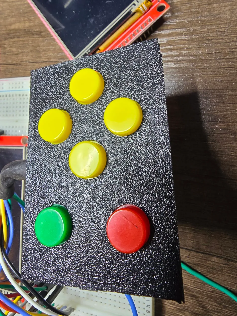 Textured test print of the six-button plate sitting over the breadboard wiring