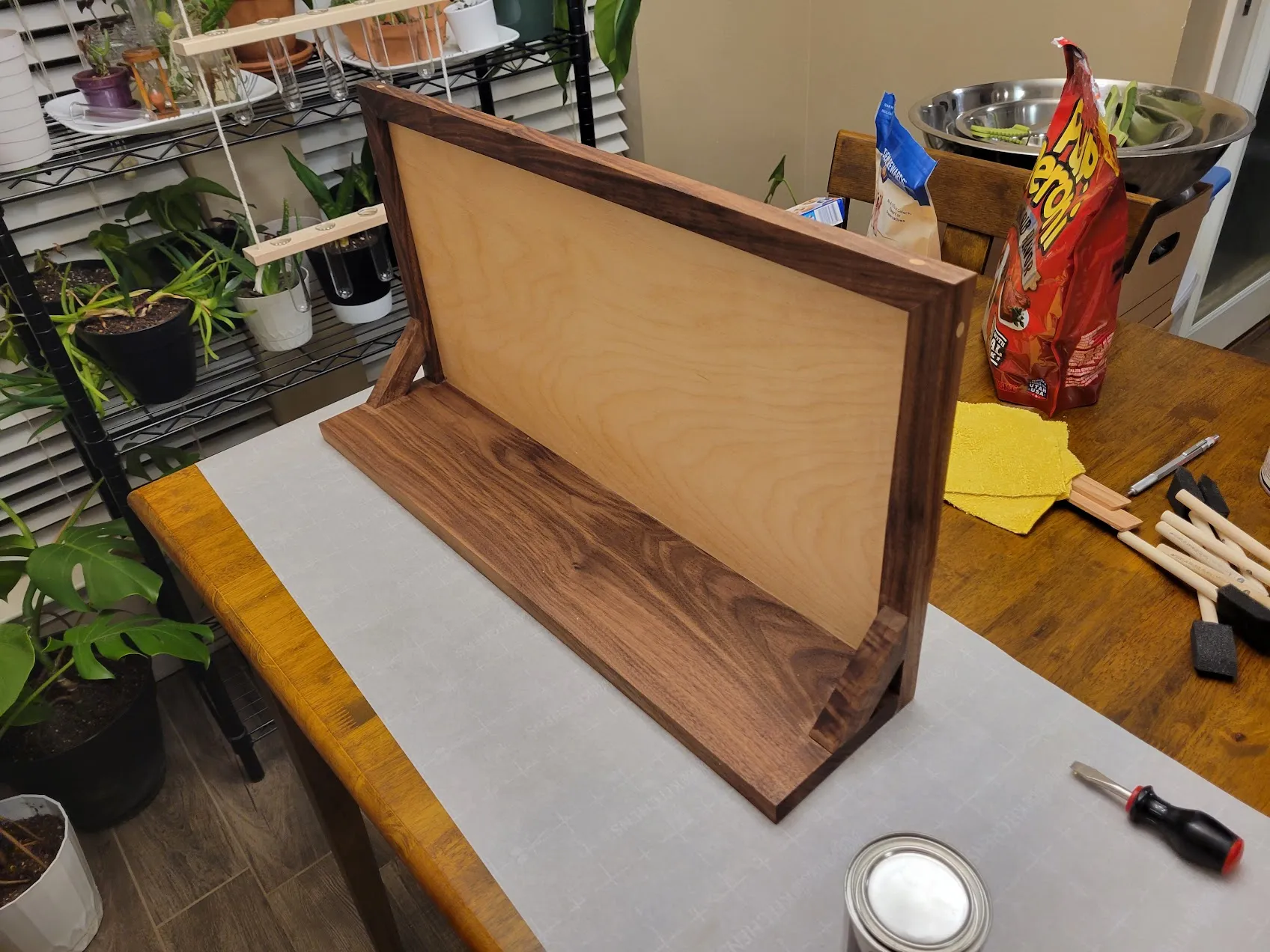 Frame and shelf after the first coat of stain, plywood panel still light