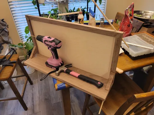 Walnut frame and shelf assembly showing dowel pins in the joints