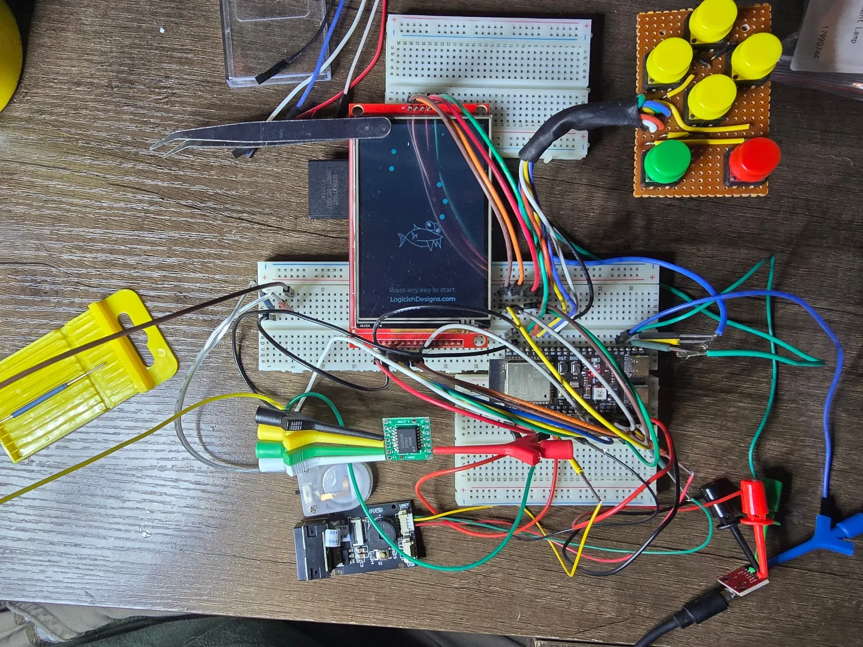 Top-down view of the full breadboard build with display, button array, ESP32-S3, barcode scanner, and RTC breakout connected