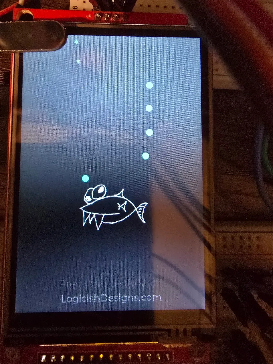 Screensaver showing the hand-drawn fish mid-screen trailing a stream of bubbles