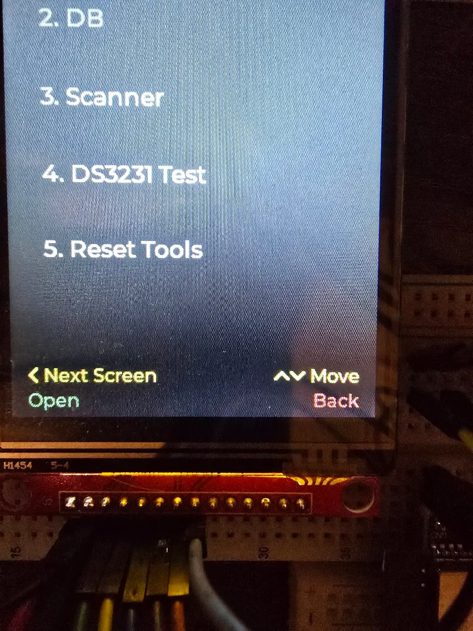 Device menu screen with a green “Open” label and a red “Back” label in the button legend